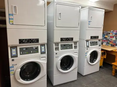 four washers and dryers in a laundry room at Banff Boundary Lodge Mountain View 2Brms 3xAC Townhouse in Canmore