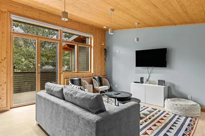 a living room with a couch and a tv at Pyrenees #202 - LEED Gold Certified in Canmore