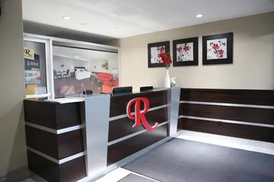 a restaurant with a red logo on the door at Royal Lodge in Edmonton