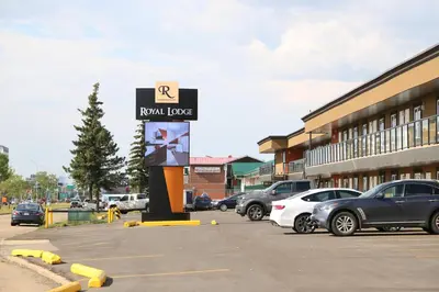 a parking lot with cars parked in front of a building at Royal Lodge in Edmonton