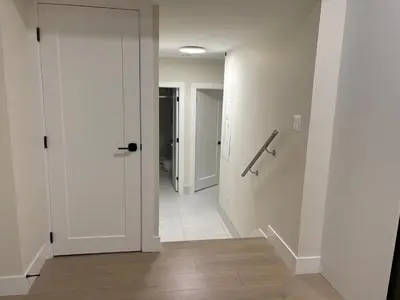 a hallway with a white door and a hallway with a hallway at Sunny White Rock 2BR, Steps to Sand, Brand New Stay in White Rock