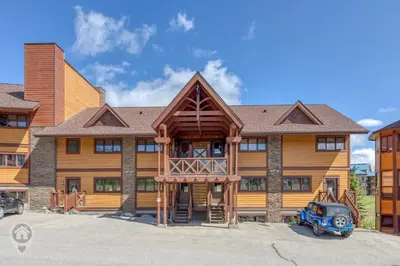 a large wooden house with a car parked in front at Timberstone Lodge by StayIn in Kimberley