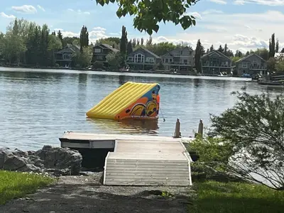 a yellow slide in the middle of a lake at Calgary Lake House B&B in Calgary