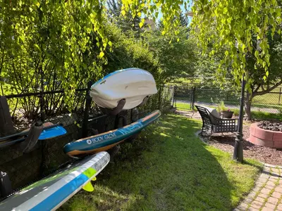 a group of kayaks and a bag on a fence at Calgary Lake House B&B in Calgary