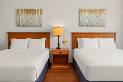 two beds sitting next to each other in a room at Comfy Rockies Retreat for 4 Canmore DT Near Banff in Canmore
