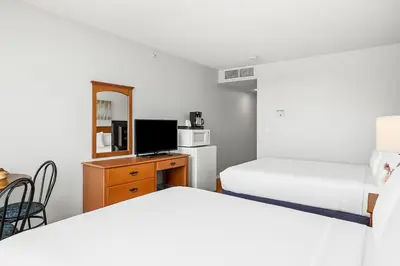 a bedroom with two beds and a desk with a tv at Comfy Rockies Retreat for 4 Canmore DT Near Banff in Canmore