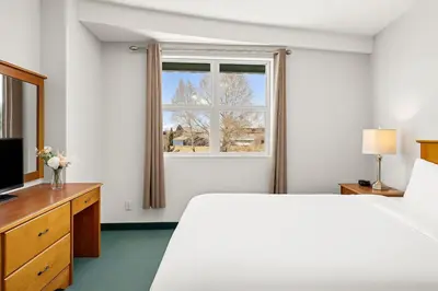a hotel room with a bed and a window at Cozy Hideaway with MTN Views Near DT Canmore and Banff in Canmore