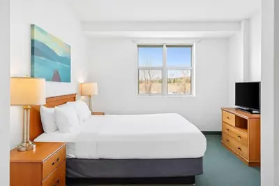 a hotel room with a bed and a television at Serene 1BR Retreat with Mountain Views in Canmore