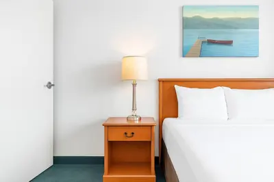 a bedroom with a bed and a lamp on a nightstand at Serene 1BR Retreat with Mountain Views in Canmore