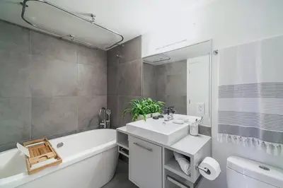 a bathroom with a white tub and a sink and a bath tub at Gorgeous Water View Unit in Downtown Vancouver in Vancouver