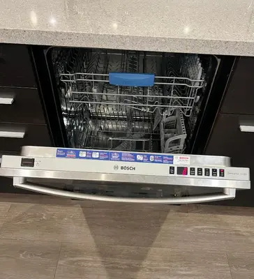 an open dishwasher with a dish rack in it at 3Bed 2Bath Steam Sauna Retreat! Family friendly! in Vancouver