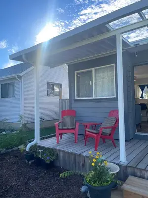 a porch with two red benches on a house at Private Luxury Relaxing HOME w BBQ & Gas Fire-pit in Hope