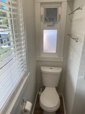 a bathroom with a white toilet and a window at Private Luxury Relaxing HOME w BBQ & Gas Fire-pit in Hope