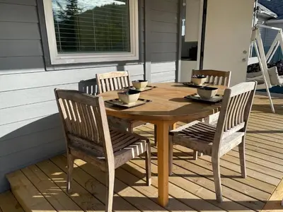 a wooden table and chairs sitting on a deck at Private Luxury Relaxing HOME w BBQ & Gas Fire-pit in Hope