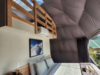 a bedroom with a bed in a dome house at Alpenrose Dome Hottubs Mountains view sleep 4 in Golden
