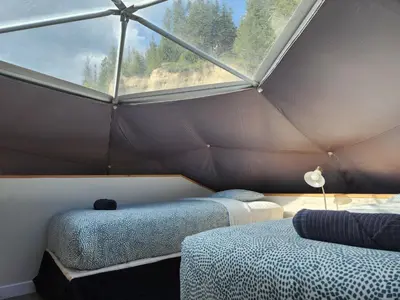 a room with two beds and a large window at Alpenrose Dome Hottubs Mountains view sleep 4 in Golden