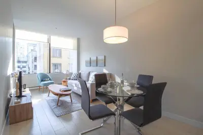 a living room with a table and a couch at Beautiful Downtown Unit in Vancouver