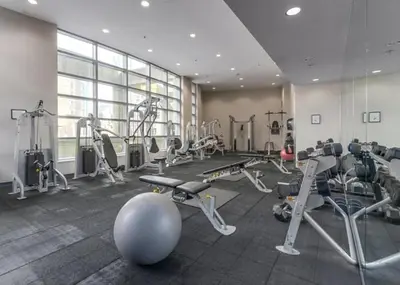 a gym with treadmills and machines in a room at Bright 3BR Downtown Vancouver Condo w Pool & Gym in Vancouver