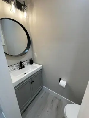 a bathroom with a sink and a mirror at Creekside Oasis on Mara in Sicamous