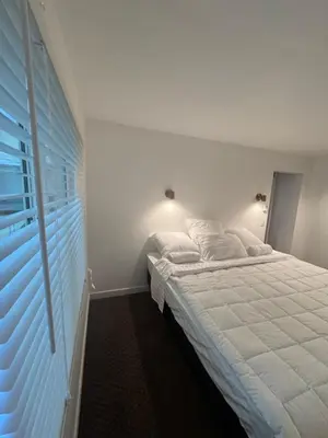 a bedroom with a white bed and a window at Sasha-Home 538 Brookmere Ave in Coquitlam
