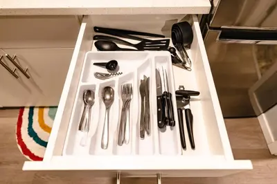 a drawer with silver utensils in a cabinet at Abraham - Peaceful cabin in historic Nordegg in Nordegg