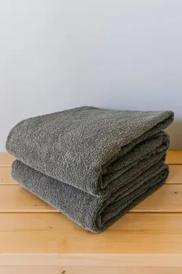 a pile of grey towels sitting on a table at Adventure Knap Shack in Nordegg