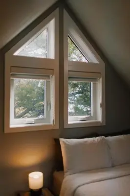 two windows in a room with a couch in front at Baldy- Modern tiny home in historic Nordegg in Nordegg