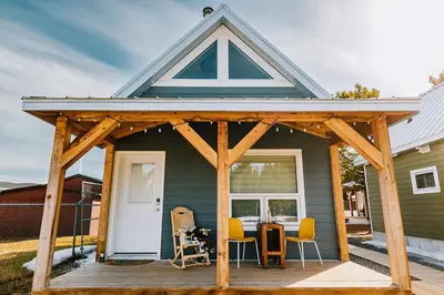 awning on a house with a table and chairs at Coliseum - Get Back to Nature in Nordegg