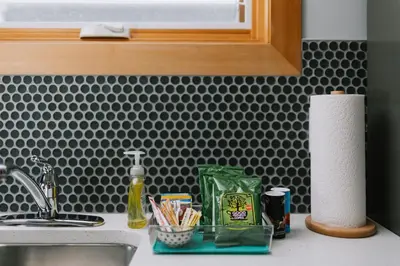 a kitchen counter with a sink and a counter top with paper towels at Coliseum - Get Back to Nature in Nordegg
