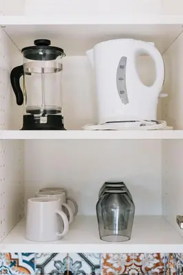 a shelf with a blender and other kitchen items at Trailhead Tuck-Inn in Nordegg