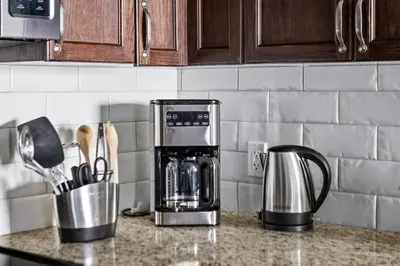 a kitchen counter with a coffeemaker and a coffee maker at Chic Rockies Getaway - Pool & Hot Tub - King Bed - BBQ! in Canmore