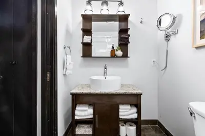 a bathroom with a sink and a mirror at Chic Rockies Getaway - Pool & Hot Tub - King Bed - BBQ! in Canmore