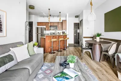 a living room with a couch and a table at Chic Rockies Getaway - Pool & Hot Tub - King Bed - BBQ! in Canmore