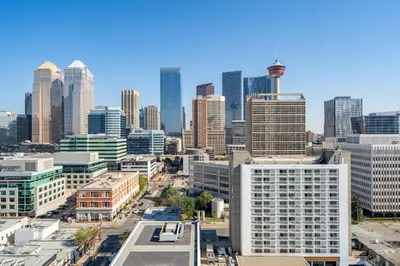 a view of a city skyline with tall buildings at The Prime Downtown | Luxe Condo + Free Parking in Calgary