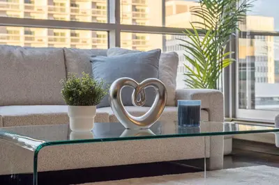 a heart sculpture on a coffee table in a living room at The Chic Downtown Residence | Luxe + Free Parking in Calgary