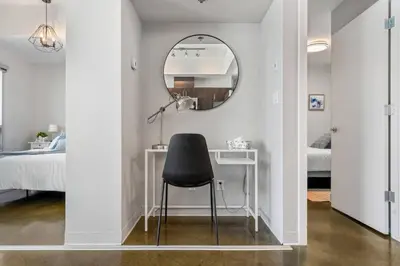 a black chair sitting at a desk in a bedroom at Downtown Chic Retreat | Elegant + Free Parking in Calgary
