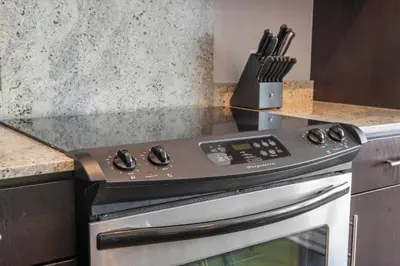 a kitchen with a stove top oven in a kitchen at Downtown Chic Retreat | Elegant + Free Parking in Calgary