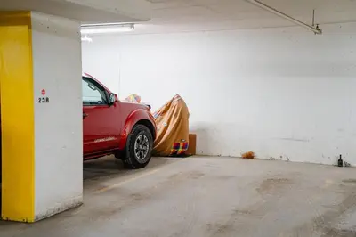 a red car parked in a parking garage at Downtown Chic Retreat | Elegant + Free Parking in Calgary