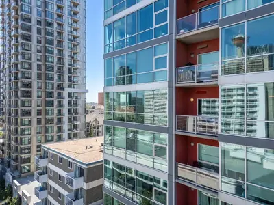an apartment building with balconies and apartments at Downtown Chic Retreat | Elegant + Free Parking in Calgary