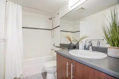 a bathroom with a sink and a toilet and a shower at Executive Unit with Spectacular Views in Vancouver