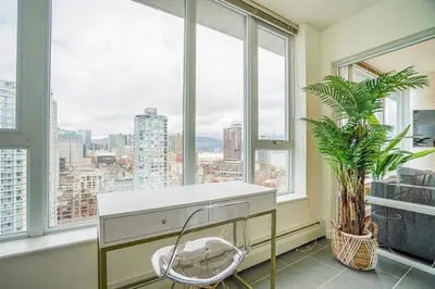 a white desk in a room with windows at Executive Unit with Spectacular Views in Vancouver