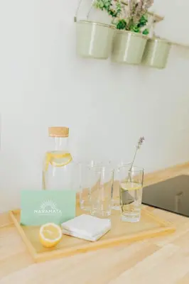 a table with glasses and vases on top of it at Naramata Courtyard Suites in Naramata