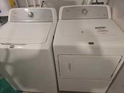 two white refrigerators are sitting next to each other at Cozy 2-Bedroom Suite 5 Minutes Walk to Chestermere Lake in Chestermere