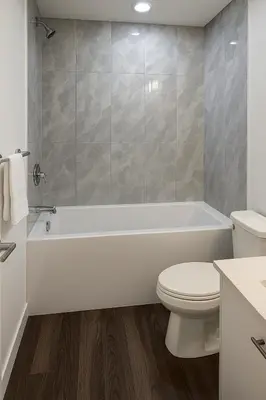 a bathroom with a white tub and a toilet at Cozy 2-Bedroom Suite 5 Minutes Walk to Chestermere Lake in Chestermere