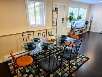 a dining room with a glass table and chairs at The open nest in Delta