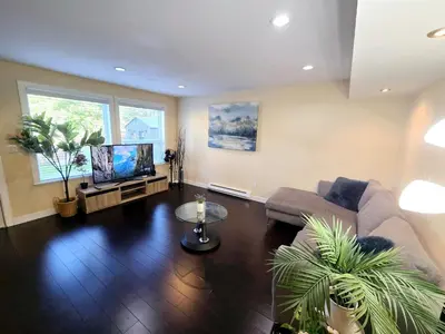 a living room with a couch and a tv at The open nest in Delta