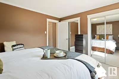 a bedroom with a large white bed with a tray on it at Condo Unit-UofA, UofA Hospital, Whyte Ave, Trails! in Edmonton