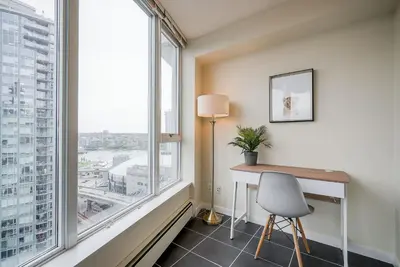a room with a desk and a large window at Gorgeous Unit with Beautiful City Views in Vancouver