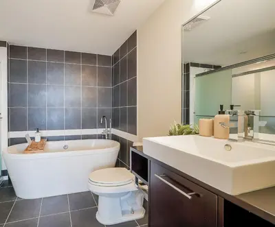 a bathroom with a tub and a toilet and a sink at Gorgeous Unit with Beautiful City Views in Vancouver