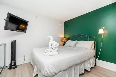 a bedroom with a bed with a stuffed animal on it at Trendy Loft in Downtown in Vancouver